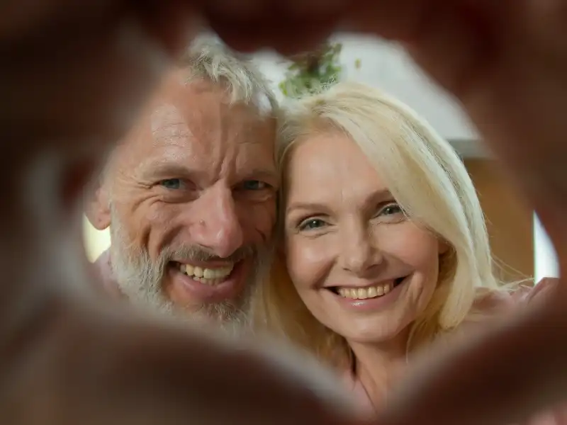 Couple holding hands in heart shape